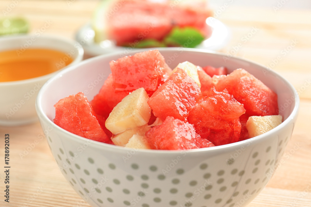 Bowl of fresh salad with watermelon on table, closeup Bowl of fresh salad with watermelon on table, closeup