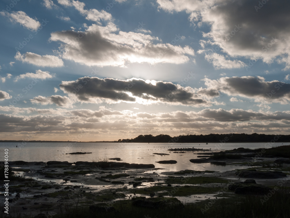 Fototapeta premium beautiful sunset over harbour coast sea bay clouds silhouette of birds landscape