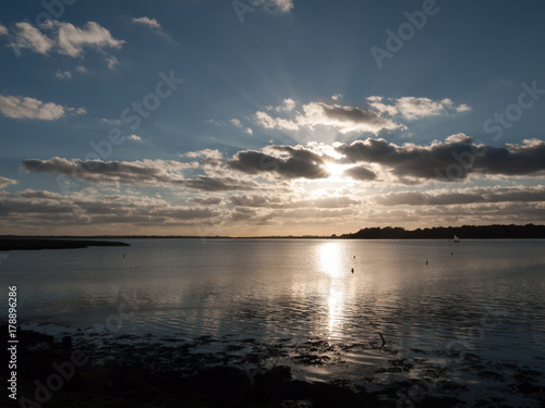 beautiful sunset over harbour coast sea bay clouds silhouette landscape