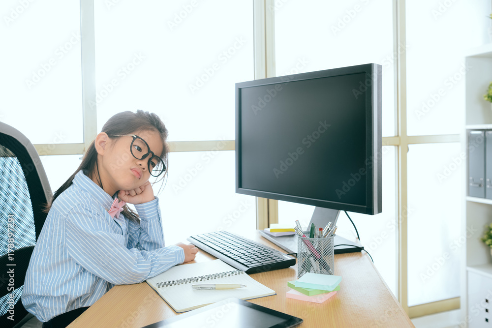 young little business girl sitting on working desk