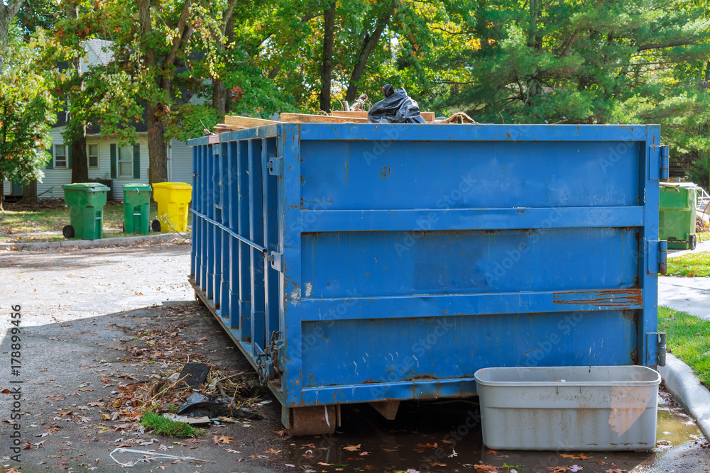Loaded dumpster near a construction