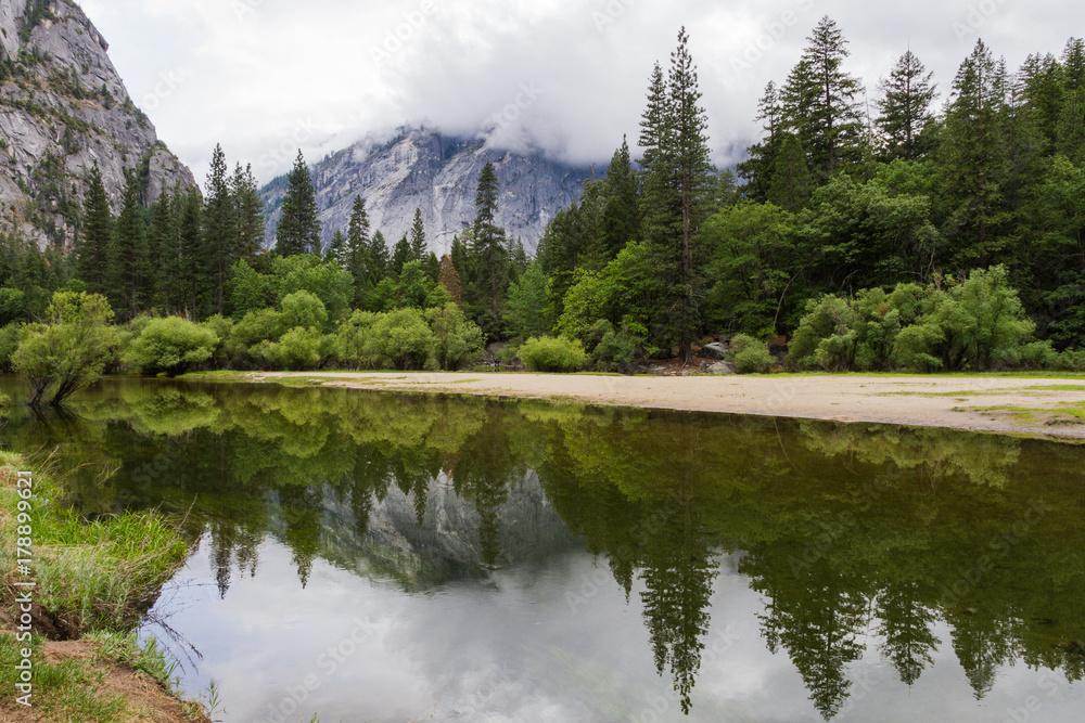 Lake reflection of mountain view and trees, Yosemite National Park, California, USA