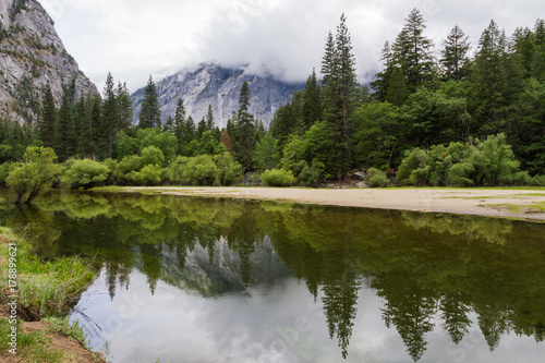 Fototapeta Naklejka Na Ścianę i Meble -  Lake reflection of mountain view and trees, Yosemite National Park, California, USA