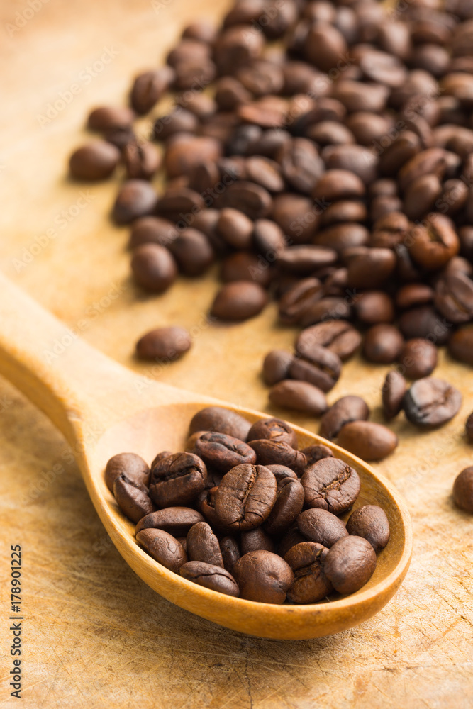 Coffee beans whit wooden spoon on wood Coffee beans whit wooden spoon on wood