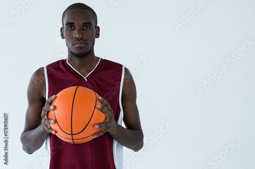 Confident player holding basketball