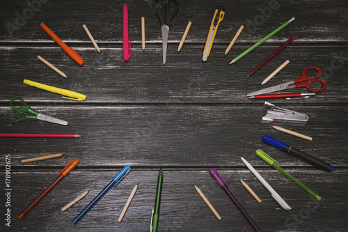Stationery - colorful pencils and stuff equipment on wooden background