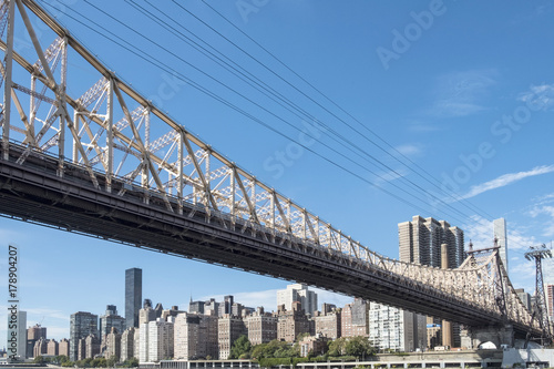Queensboro bridge and tramway cable against Manhattan skyline , New York