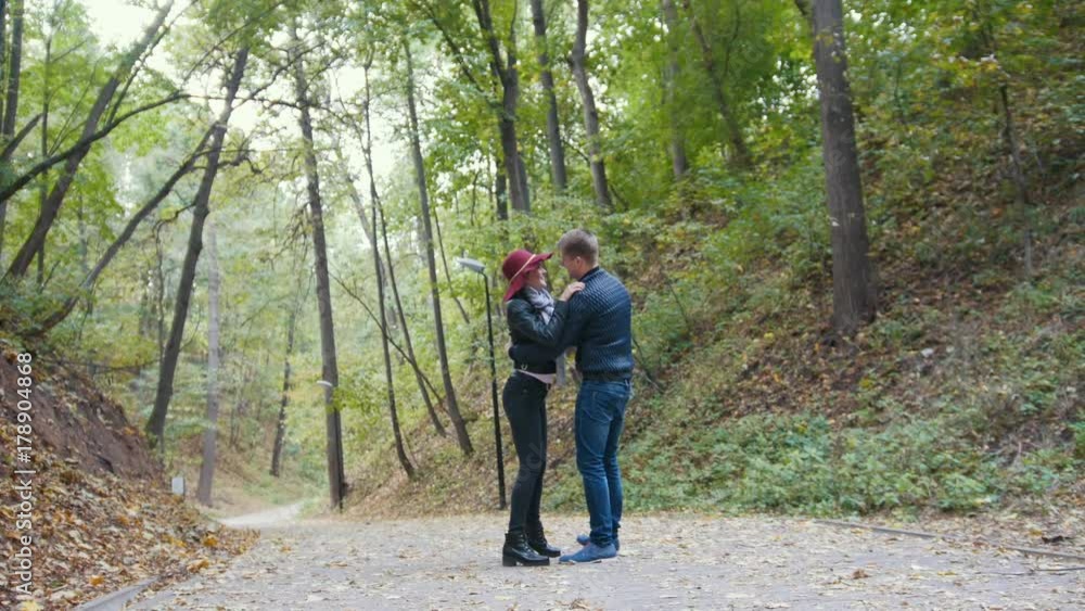 Romantic couple in autumn park among yellow leaves Romantic couple in autumn park among yellow leaves
