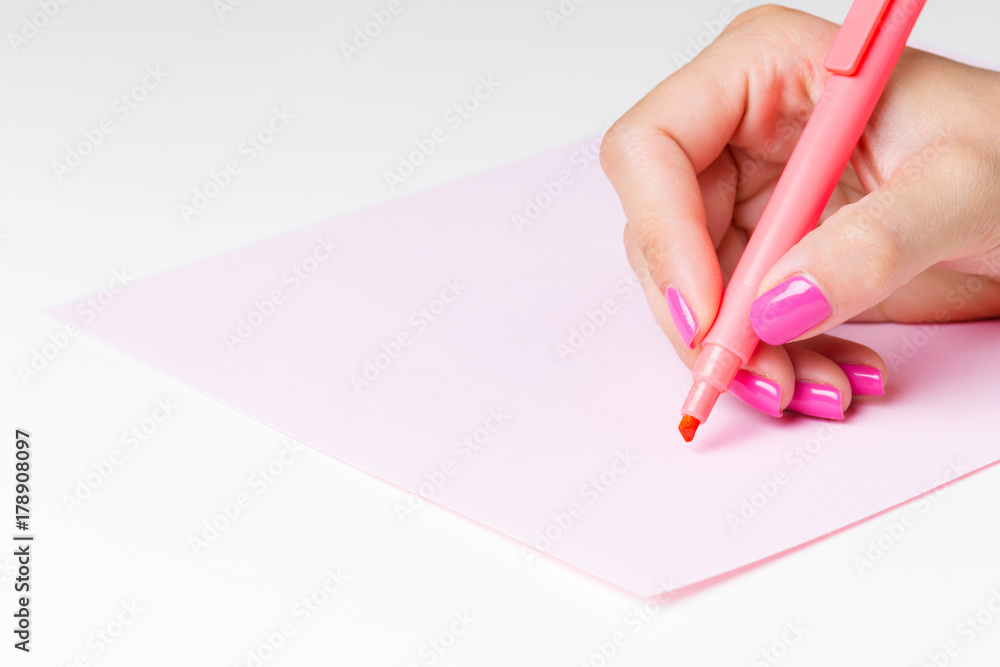 Female hand holding a pen close up Female hand holding a pen close up