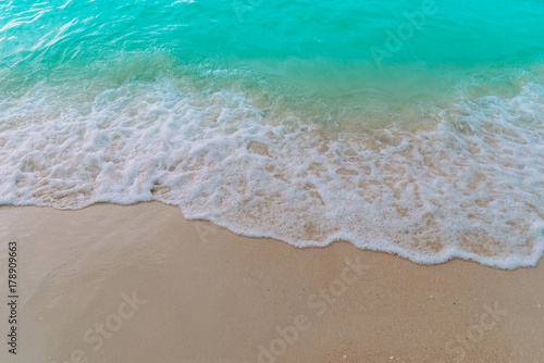 Soft wave of blue ocean with sandy on the beach nature background.Summer concept,