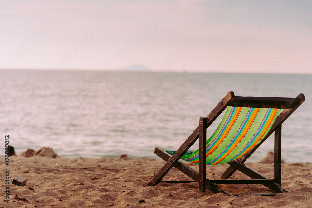 chair beach with sunset and blue sky background.vintage tone. Travel concept.