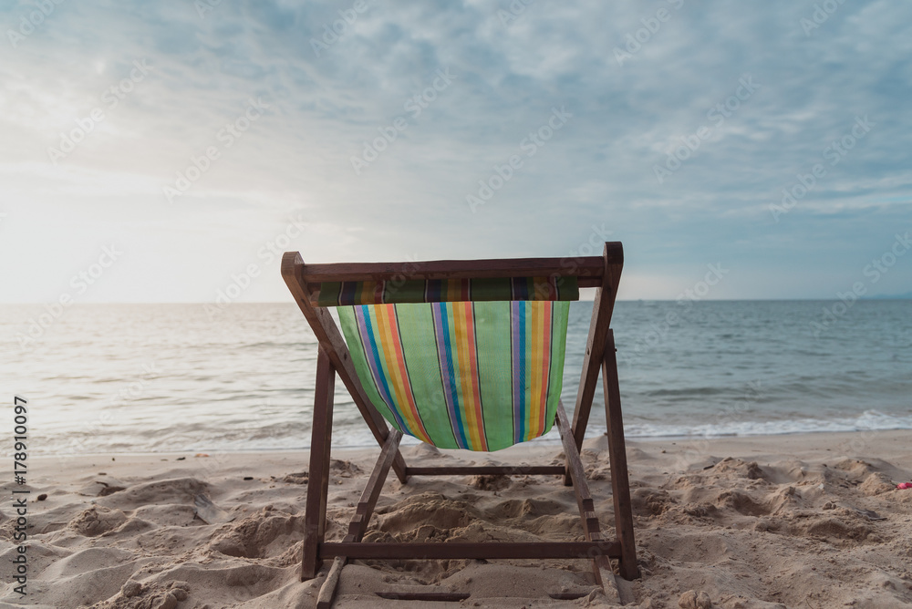 chair beach with sunset and blue sky background.vintage tone. Travel concept.