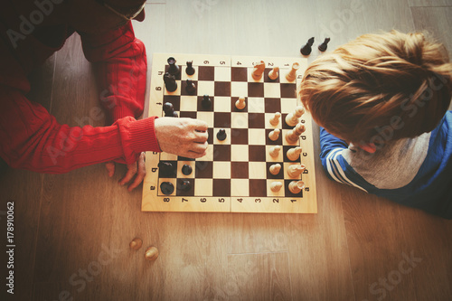 teacher and kid play chess in school