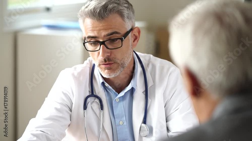 Doctor talking to patient in office