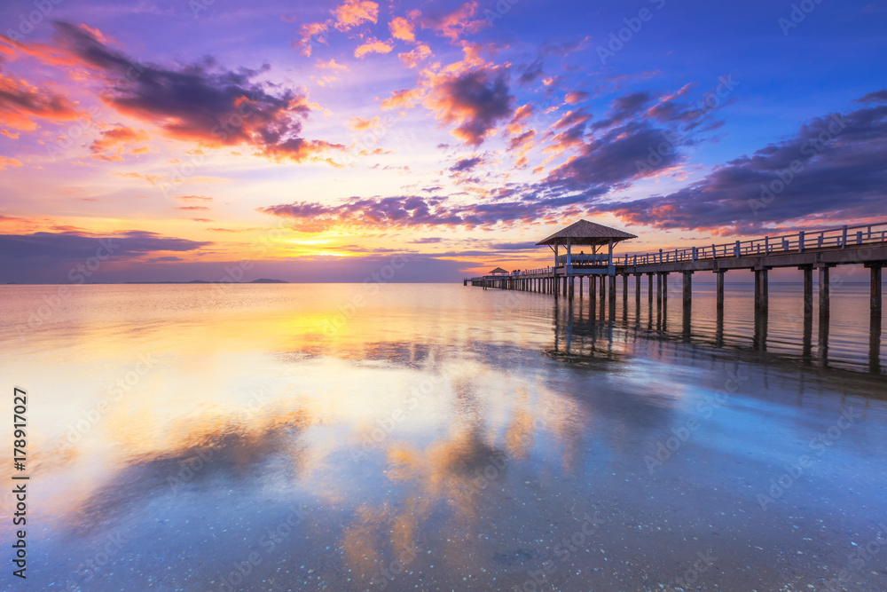 Old wood bridge pier against beautiful sunset sky use for natural background ,backdrop and multipurpose sea scene