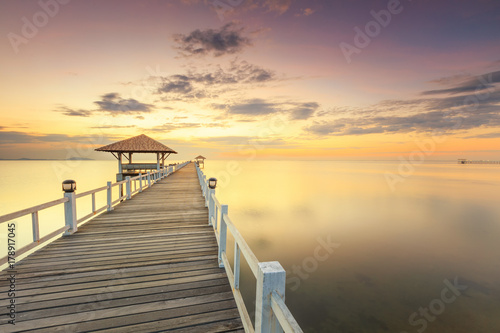 Old wood bridge pier  against beautiful sunset sky use for natural background  backdrop and multipurpose sea scene