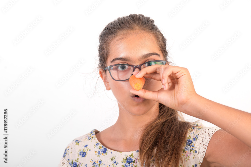 Funny girl with  carrot. Cheerful snowman. Vitamins for teenagers. Vegetabl for healthy eating of children. Positive weight loss. Portrait of  girl with carrot.
