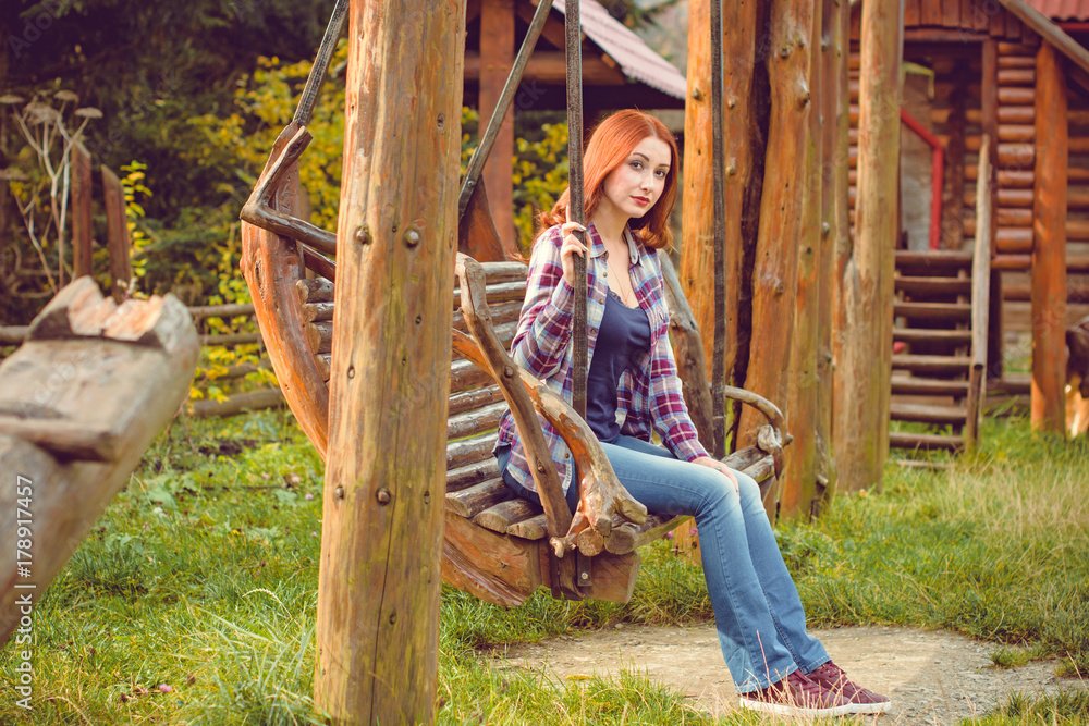 American girl from next door, simple and nice young woman in plaid shirt and jeans on a nature. Rest in autumn forest or countryside. Feeling freedom and inspiration American girl from next door, simple and nice young woman in plaid shirt and jeans on a nature. Rest in autumn forest or countryside. Feeling freedom and inspiration