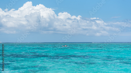 Panorama of the lagoon and the coral reef in background in Tahiti  with a kayak on the lagoon  