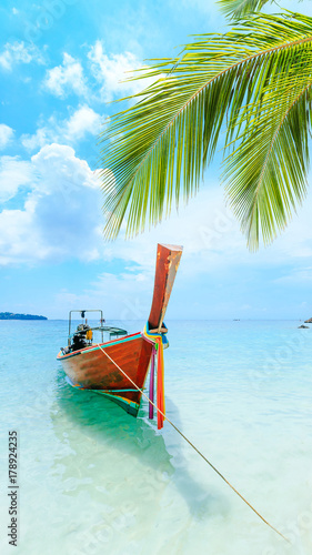 Longtale boat on the white beach at Phuket, Thailand. Phuket is a popular destination famous for its beaches.