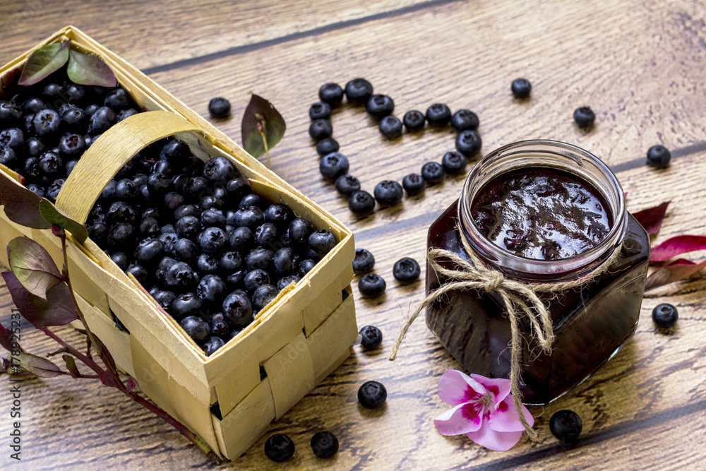 Homemade blueberry jam; Basket full with fress blueberries; Healthy heart symbol Homemade blueberry jam; Basket full with fress blueberries; Healthy heart symbol