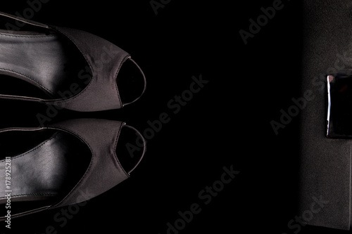 Fashion Lady Accessories Set. Minimal. Black Shoes and bag on black background. Flat lay.