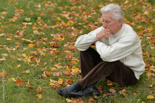 thoughtful senior man in park