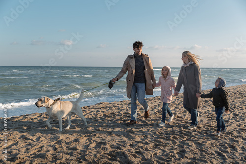family walking with dog