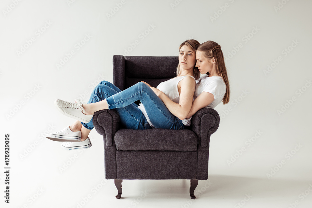 Homosexual couple sitting on armchair Homosexual couple sitting on armchair