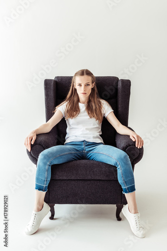 Girl sitting on armchair