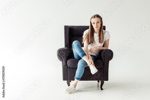 Girl sitting on armchair