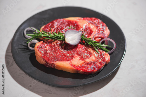Raw fresh beef on white stone background, top view