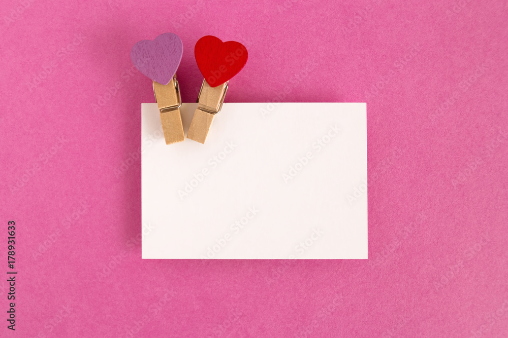 White sheet with red and purple pins on the pink background for Valentine Day. Copy space. White sheet with red and purple pins on the pink background for Valentine Day. Copy space.
