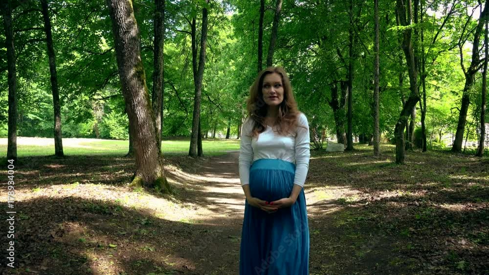 Caucasian pregnant woman with big tummy spent lifestyle in park Caucasian pregnant woman with big tummy spent lifestyle in park