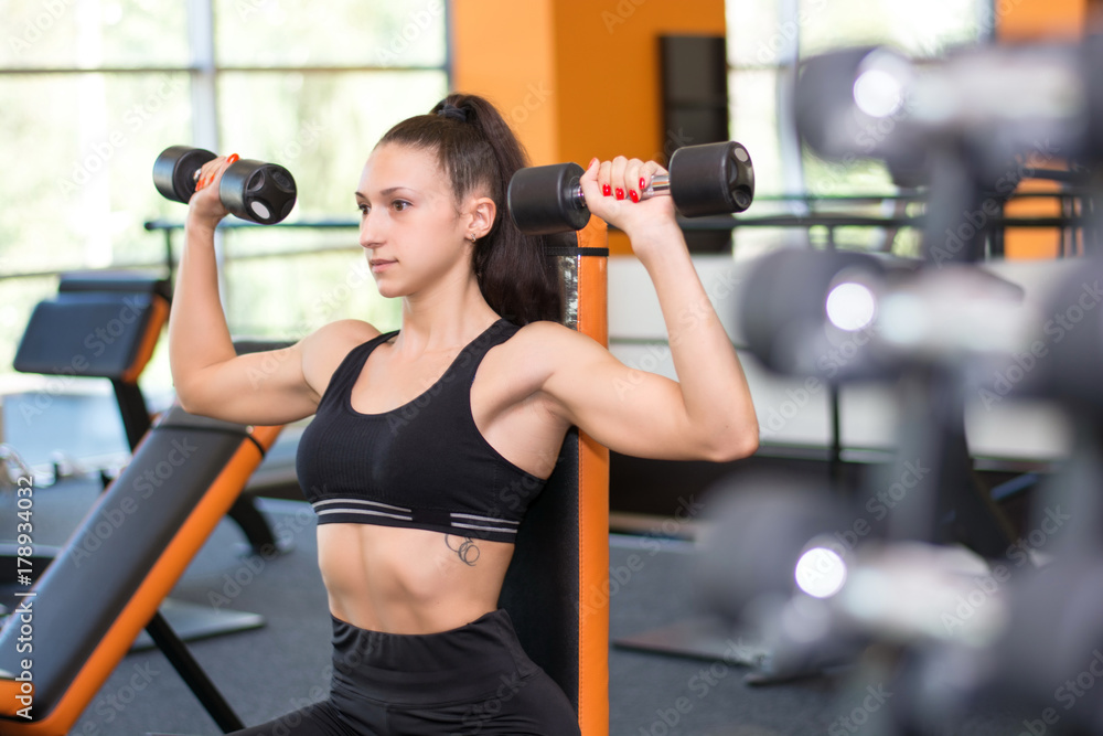 © syhin_stas - Girl with dumbbells in the gym