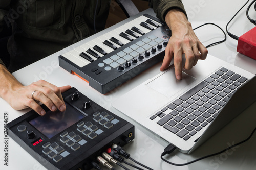 Photography Producing electronic music on laptop with portable midi keyboard and electronic effect processors