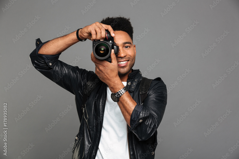 Portrait of a smiling afro american guy in leather jacket Portrait of a smiling afro american guy in leather jacket