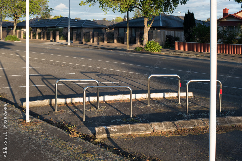 An empty street at sunset with long shadows cast by the evening sun An empty street at sunset with long shadows cast by the evening sun