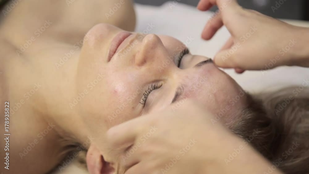 masseur makes acupressure on a female face. Chinese alternative medicine masseur makes acupressure on a female face. Chinese alternative medicine