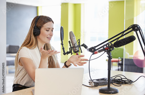 Young woman broadcasting in a studio gesturing  close up