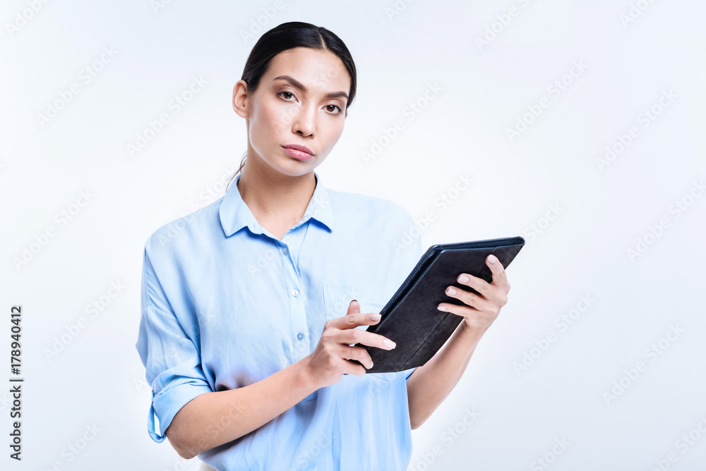 Beautiful woman in blue shirt holding a tablet Beautiful woman in blue shirt holding a tablet
