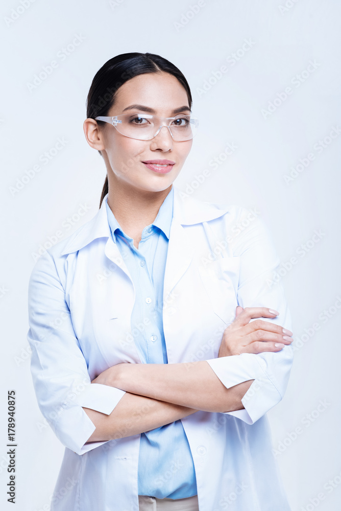 Cheerful lab worker in safety glasses posing against white background Cheerful lab worker in safety glasses posing against white background