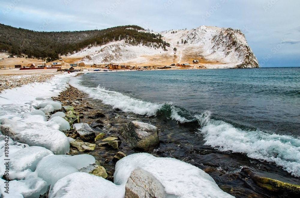 Waves and splash on Lake Baikal with rocks and trees near Uzuri village