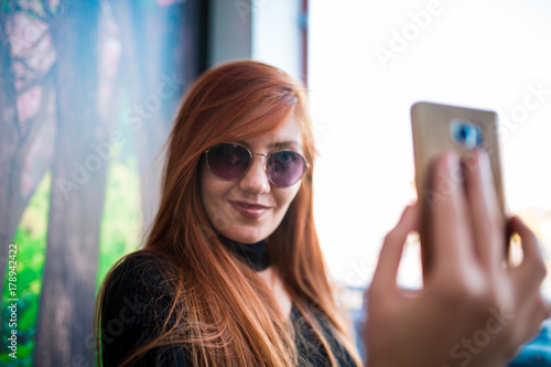 Beautiful girl drinking coffee at the coffee shop