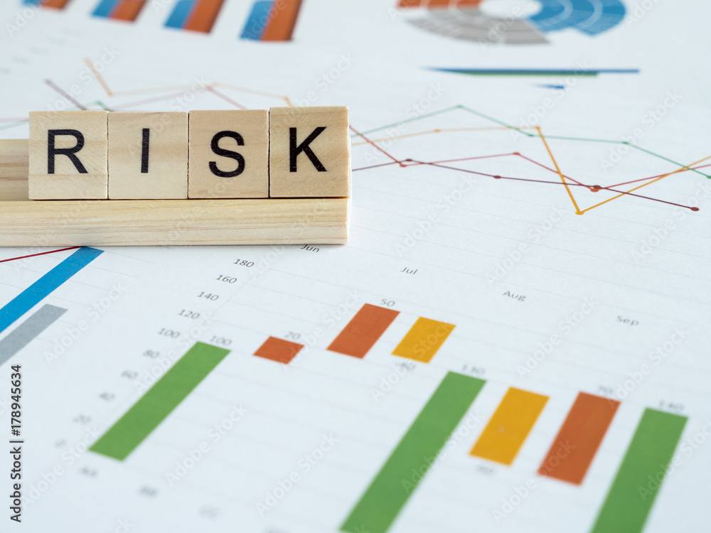 Fototapeta premium Word spell Risk over graph and chart report 1