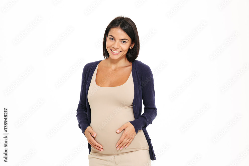 Portrait of a happy young pregnant woman touching her belly Portrait of a happy young pregnant woman touching her belly