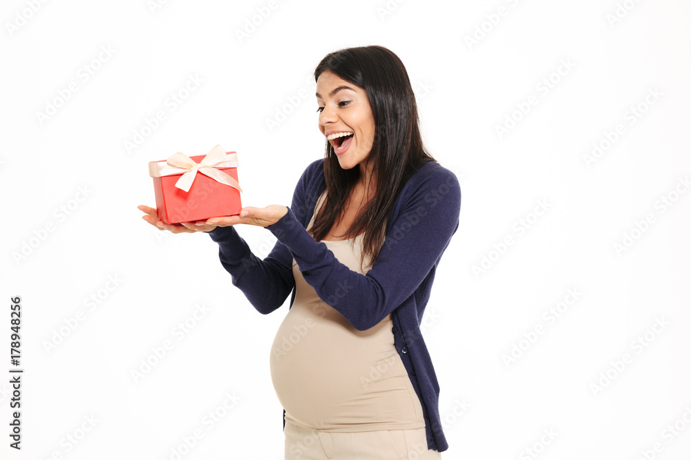 Portait of a cheerful happy pregnant woman holding gift box Portait of a cheerful happy pregnant woman holding gift box