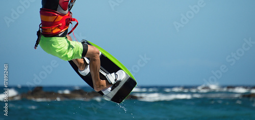 Kite surfer flying over the wave,kite surfing in blue sea