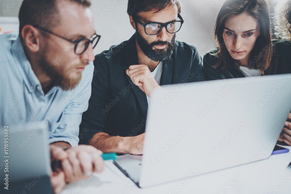 Project team working together in meeting room at night office.Brainstorming process concept.Horizontal.Blurred background.Cropped. Project team working together in meeting room at night office.Brainstorming process concept.Horizontal.Blurred background.Cropped.
