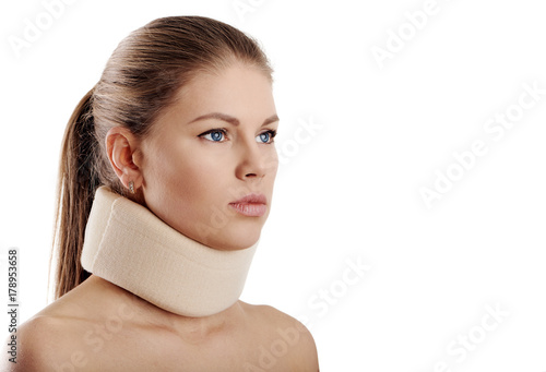 Close up of young female wearing neck collar on white background. Concept of osteoporosis or neck injury. 